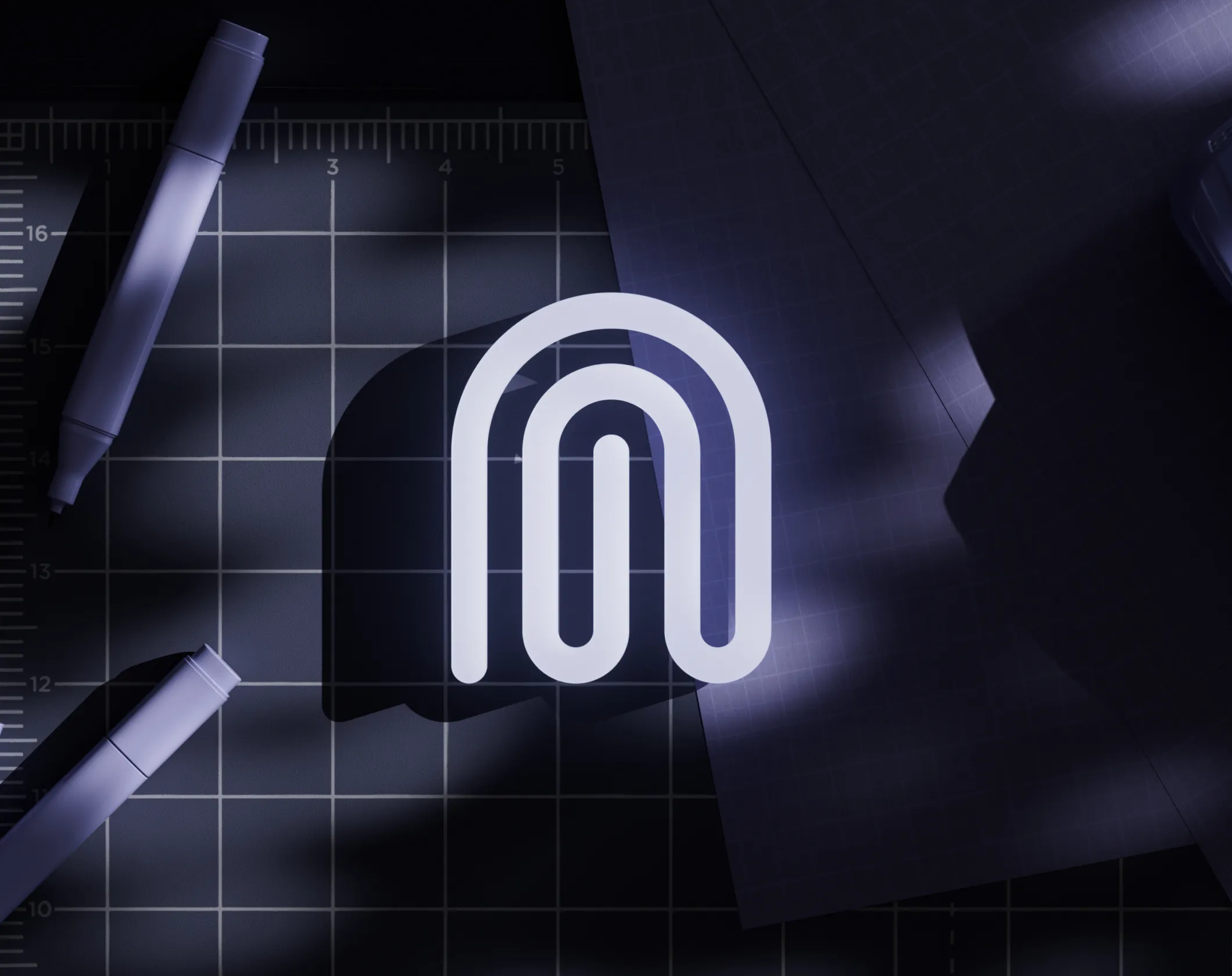 The Ghost mark on a cutting mat beside a pen
