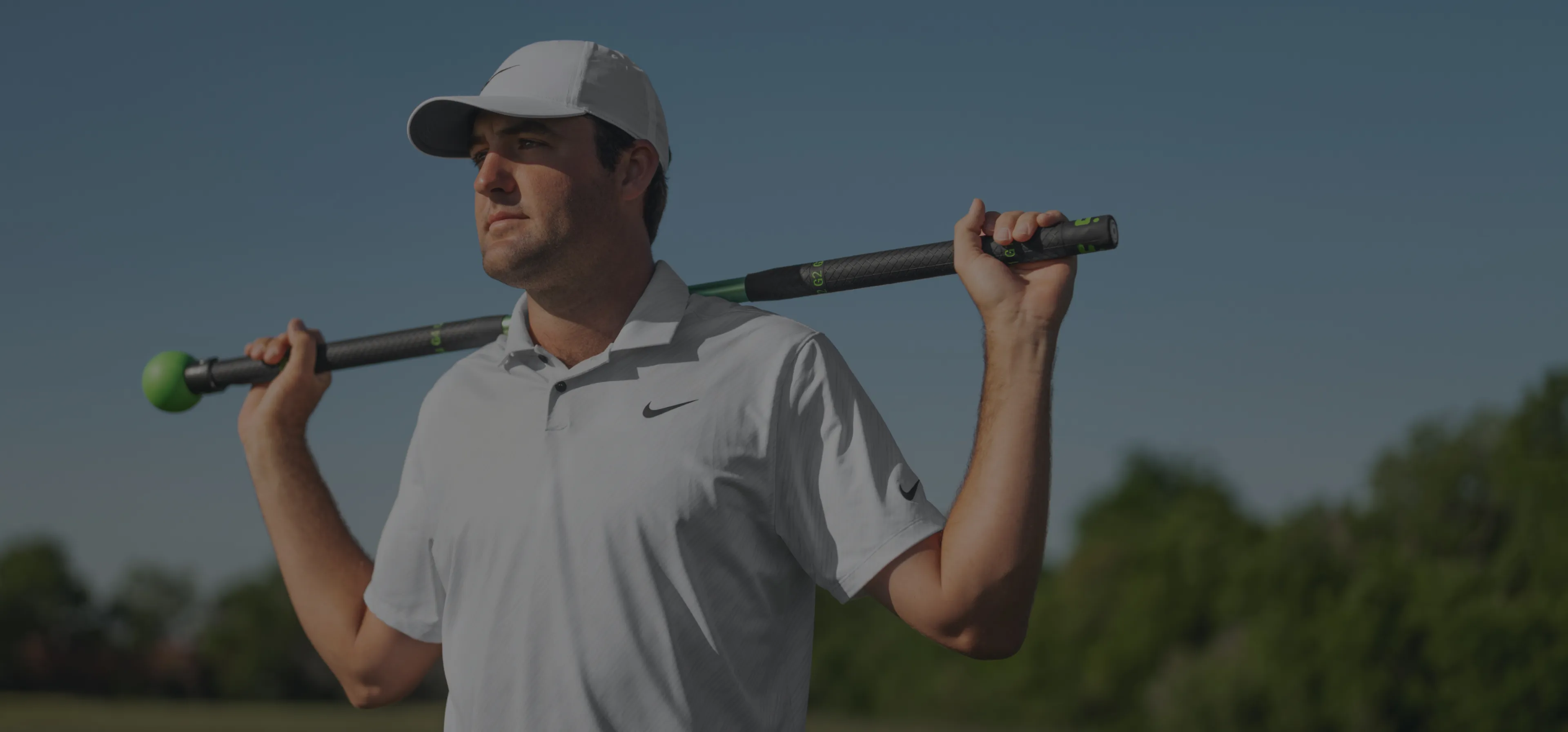 A golfer holding the GolfForever training bar across his shoulders